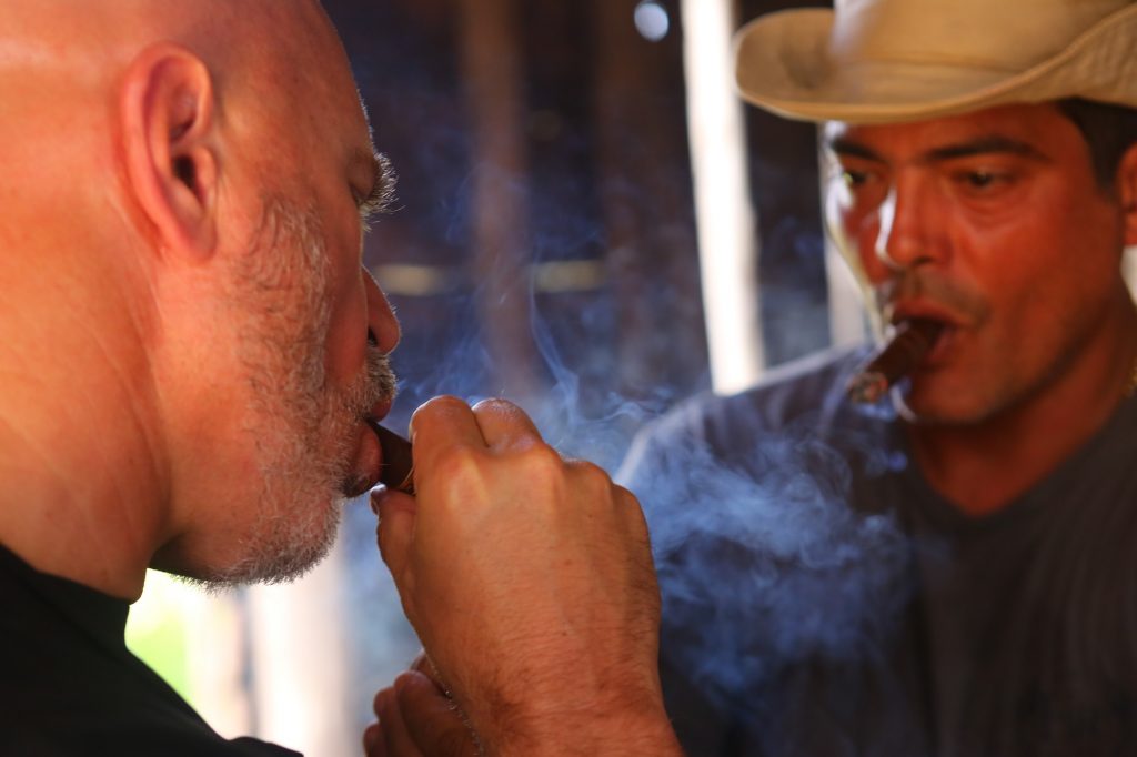 CNN TV anchor Michael Smerconish and tobacco farmer Hiroshi Robaina enjoy a cigar together, Cuba; copyright Christopher P Baker